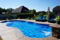 Backyard swimming pool with clear blue water