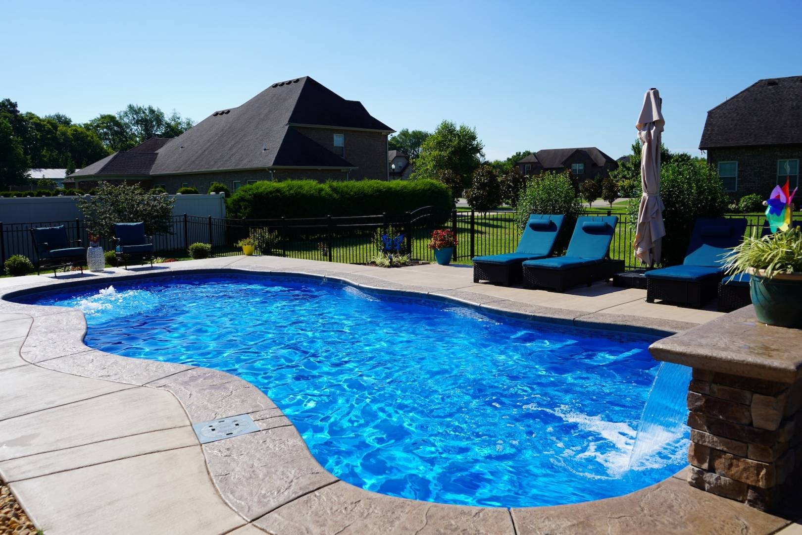 Backyard swimming pool with clear blue water