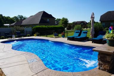 Backyard swimming pool with clear blue water