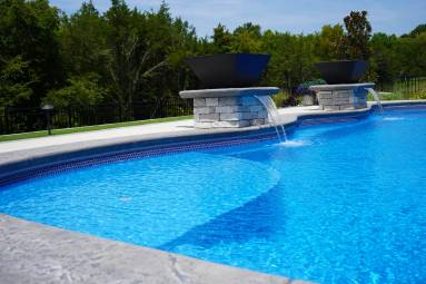 Backyard swimming pool with blue water and fountain
