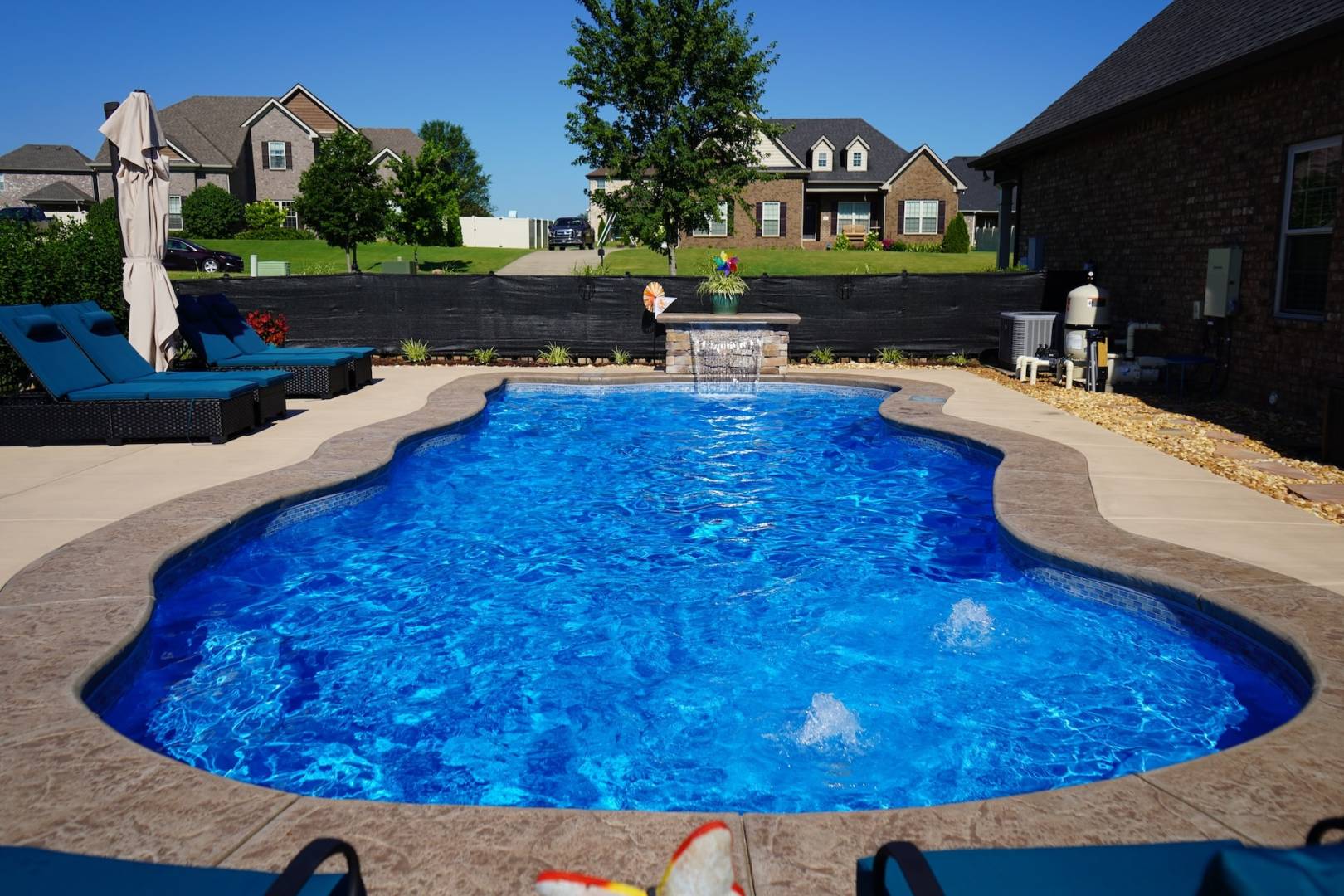 Backyard swimming pool with clear blue water