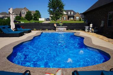 Backyard swimming pool with clear blue water