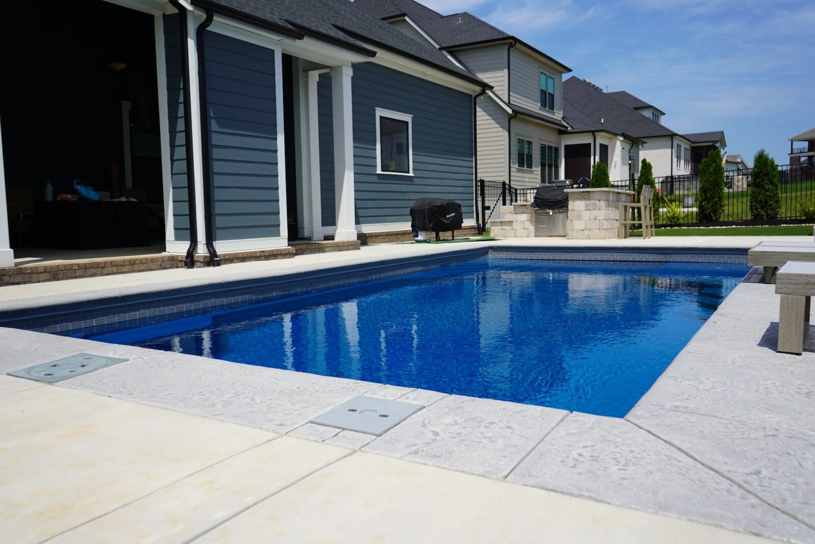 Backyard swimming pool by modern family homes